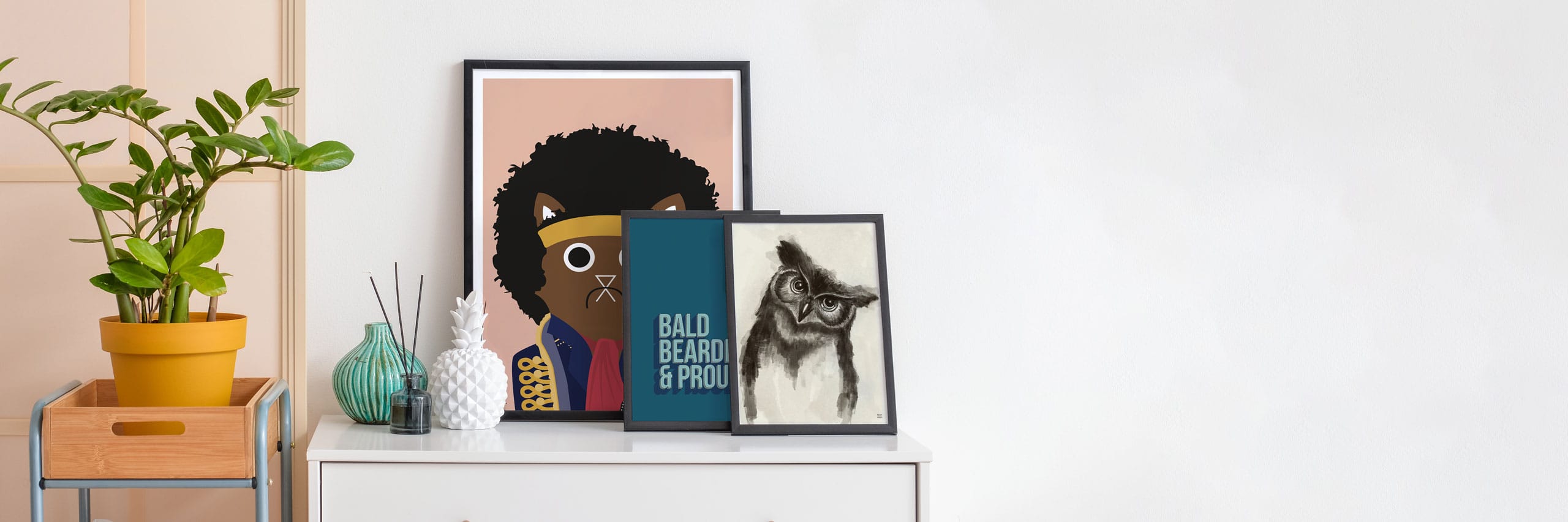 A selection of various wall art print example on a sideboard