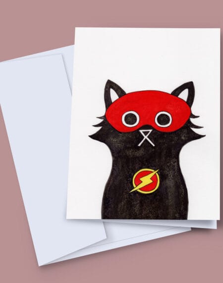 A 7x5 inch greeting card featuring an ink and salt black cat illustration wearing Flash's mask and lightning bolt