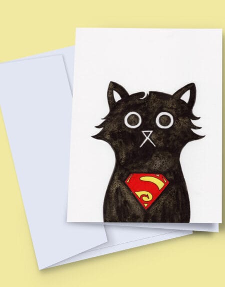 A 7x5 inch greeting card featuring an ink and salt black cat illustration wearing Superman's logo on his chest