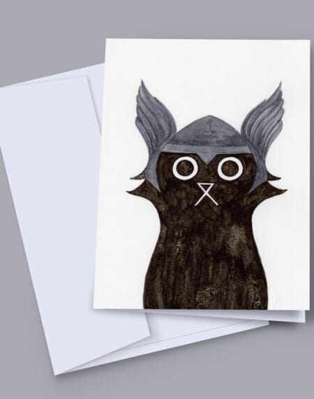 A 7x5 inch greeting card featuring an ink and salt black cat illustration wearing Thor's helmet