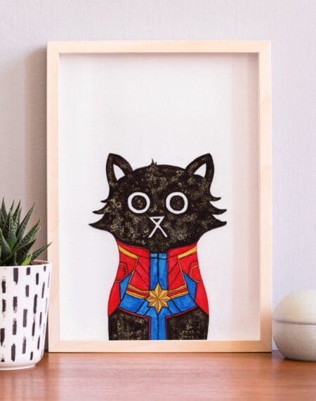 hand-drawn salt and ink illustration print, depicting a cute cat dressed as Captain Marvel