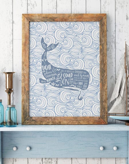 a typographic illustration print of a whale with wording over the top, surrounded by waves