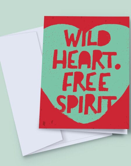 a 7x5 inch greeting card featuring a typographic illustration print set within a turquoise heart, on a red background