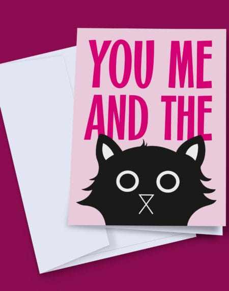 You Me and The Cat. A greeting card with the words "You Me and The" in bright pink, on a light pink background, with a black cats head poking up from the bottom.